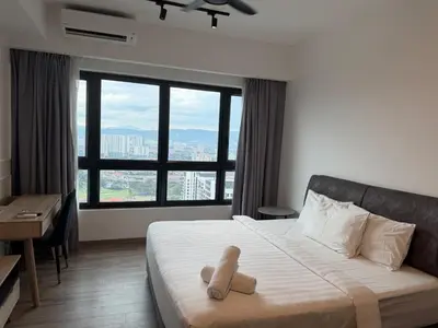 a teddy bear sitting on a bed in a hotel room at Bukit Bintang Suites KLCC by YBS in Kuala Lumpur
