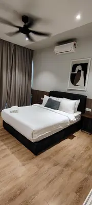 a bedroom with a bed with a ceiling fan at Queen Suites at Quill Residence KL in Kuala Lumpur