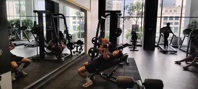 a group of people exercising in a gym at Queen Suites at Quill Residence KL in Kuala Lumpur