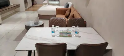 a living room with a table and a couch at Queen Suites at Quill Residence KL in Kuala Lumpur