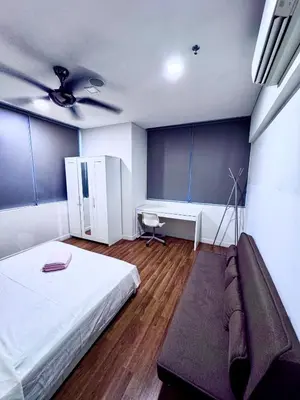 a bedroom with a bed and a couch in it at Mercu Summer Suites KLCC by Jk Privy Homes - Entire Studio in Kuala Lumpur