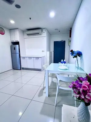 a kitchen with a white table and a white floor at Mercu Summer Suites KLCC by Jk Privy Homes - Entire Studio in Kuala Lumpur