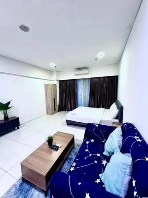 a living room with a couch and a bed at Mercu Summer Suites KLCC by Jk Privy Homes - Entire Studio in Kuala Lumpur