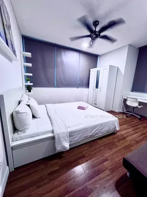a bedroom with a bed with a ceiling fan at Mercu Summer Suites KLCC by Jk Privy Homes - Entire Studio in Kuala Lumpur