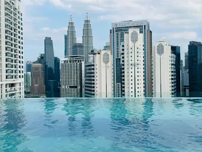 a swimming pool with a view of a city skyline at service apartment majestic city center klcc in Kuala Lumpur