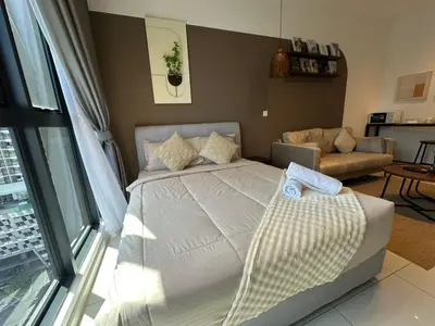 a bedroom with a bed and a living room at service apartment majestic city center klcc in Kuala Lumpur