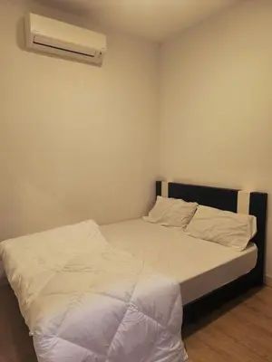 a bedroom with a bed with a air conditioner on the wall at 10 Mins to KLCC Cozy Place to Stay in Kuala Lumpur