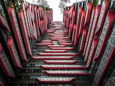 a stairway of red chairs in a building at 10 Mins to KLCC Cozy Place to Stay in Kuala Lumpur