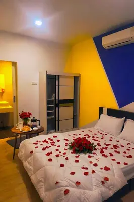 a bedroom with a bed with red roses on it at 10 Mins to KLCC Cozy Place to Stay in Kuala Lumpur