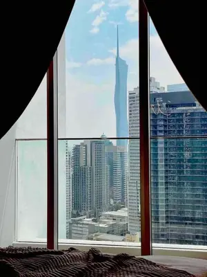 a bedroom with a view of a city from a window at Veone Hotel Kuala Lumpur in Kuala Lumpur