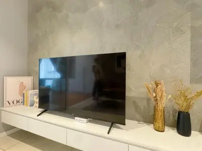 a flat screen tv sitting on top of a white cabinet at Veone Hotel Kuala Lumpur in Kuala Lumpur