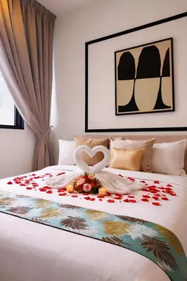 a bed with two swans and flowers on it at Future Star Chamber Residence in Kuala Lumpur