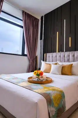 a bedroom with a large bed with a table on it at Future Star Chamber Residence in Kuala Lumpur