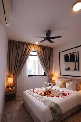 a bedroom with a bed with a flower on it at Future Star Chamber Residence in Kuala Lumpur