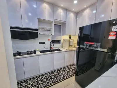 a kitchen with white cabinets and a black refrigerator at Awani3 Homestay, Setapak, KL in Kuala Lumpur