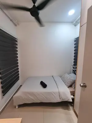 a bedroom with a bed with a black ceiling fan at Awani3 Homestay, Setapak, KL in Kuala Lumpur