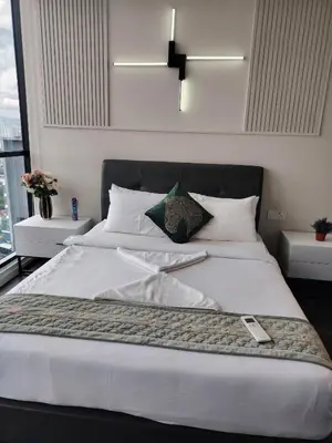 a bedroom with a large bed with white sheets at The Times Square KLCC by Bukit Bintang in Kuala Lumpur