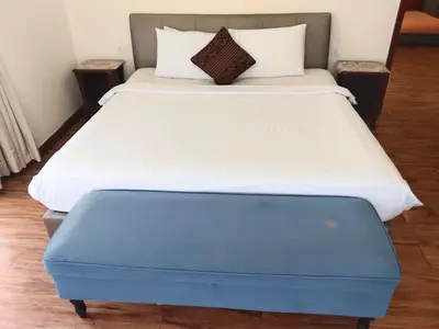 a bed with a blue ottoman in a room at The Times Square KLCC by Bukit Bintang in Kuala Lumpur