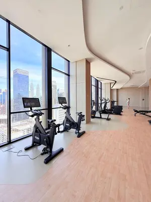 a gym with treadmills and exercise equipment in a building at Luxury Axon Residence Bukit Bintang KLCC Pavilion By EQZ in Kuala Lumpur