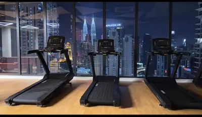 a gym with a view of a city skyline at Staycay Majestic Residence KL in Kuala Lumpur