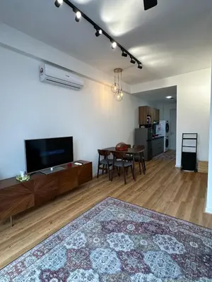 a living room with a table and a tv at Staycay Majestic Residence KL in Kuala Lumpur
