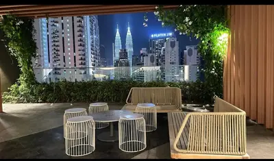 a table and chairs with a view of a city at Staycay Majestic Residence KL in Kuala Lumpur