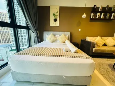 a bedroom with a large bed and a couch at LA Majestic Suites at KlCC in Kuala Lumpur