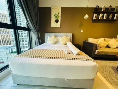 a bedroom with a large bed and a couch at LA Majestic Suites at KlCC in Kuala Lumpur