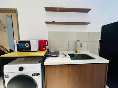 a kitchen with a sink and a washing machine at LA Majestic Suites at KlCC in Kuala Lumpur