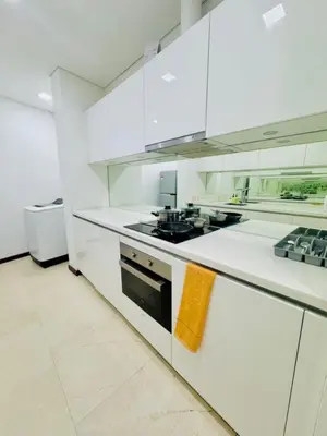 a kitchen with white cabinets and a stove top oven at Apartment Kuala Lumpur City 3 Minutes To KLCC in Kuala Lumpur