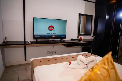 a room with a tv and a bed with towels at Axon Residences KLCC - CR Homestay in Kuala Lumpur