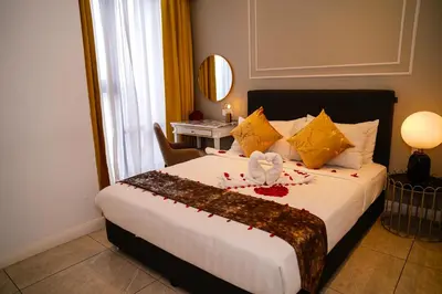 a hotel room with a bed with a bow on it at Axon Residences KLCC - CR Homestay in Kuala Lumpur