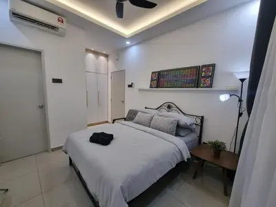 a bedroom with a bed with a black bag on it at Awani3 Homestay Setapak, KL in Kuala Lumpur