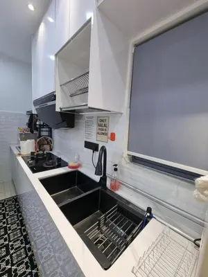 a kitchen with a sink and a stove at Awani3 Homestay Setapak, KL in Kuala Lumpur