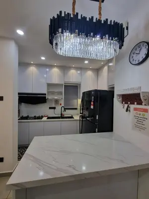 a kitchen with a clock and a chandelier at Awani3 Homestay Setapak, KL in Kuala Lumpur