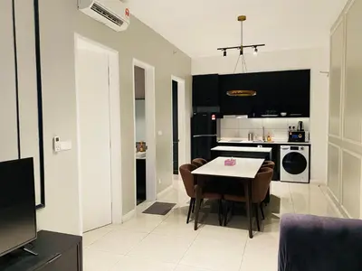 a kitchen and living room with a table and chairs at Axon Residence premium Apartment KL in Kuala Lumpur