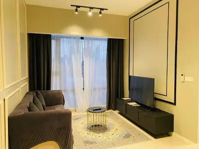 a living room with a couch and a television at Axon Residence premium Apartment KL in Kuala Lumpur