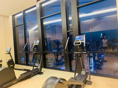 a gym with cardio machines and a view of the city at Axon Residence premium Apartment KL in Kuala Lumpur