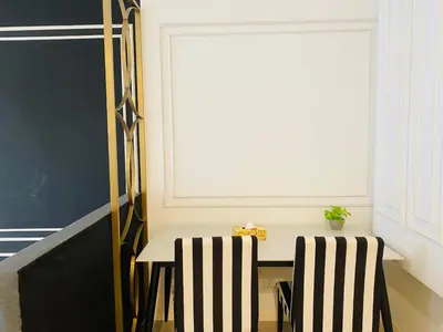 a table and two chairs in a room with a window at Axon Residence premium Apartment KL in Kuala Lumpur