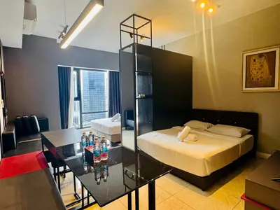 a bedroom with a bed and a table with a glass tableablish at Axon Residence premium Apartment KL in Kuala Lumpur