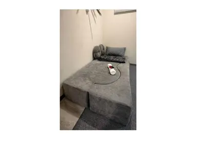 a living room with a couch and a table at pertama residency jacuzzi projector 120
