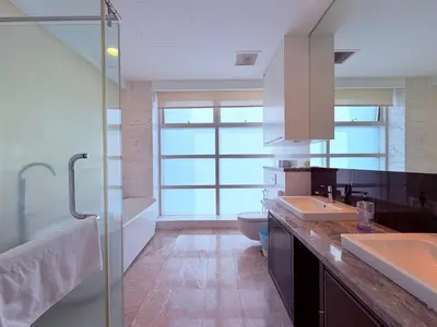 a bathroom with two sinks and a glass shower at Platinum Kuala Lumpur By NewMoon in Kuala Lumpur