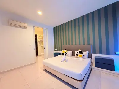 a bedroom with a bed and a green striped wall at Platinum Kuala Lumpur By NewMoon in Kuala Lumpur