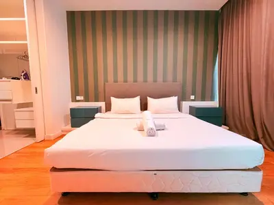 a bedroom with a large white bed with a towel on it at Platinum Kuala Lumpur By NewMoon in Kuala Lumpur