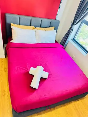 a red bed with two crosses on top of it at Chamber Luxury Suites Kuala Lampur in Kuala Lumpur