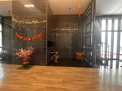 a room with a brick wall and a person sitting in a chair at Chamber Luxury Suites Kuala Lampur in Kuala Lumpur