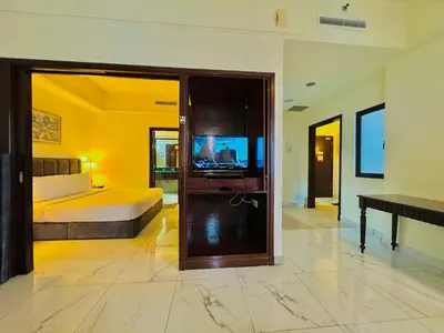 a bedroom with a bed and a television in it at Times Square Services suite at kl Bukit Bintang SAkL in Kuala Lumpur