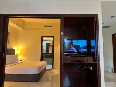 a bedroom with a bed and a flat screen tv at Times Square Services suite at kl Bukit Bintang SAkL in Kuala Lumpur