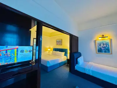a bedroom with two beds and a flat screen tv at Times Square Services suite at kl Bukit Bintang SAkL in Kuala Lumpur