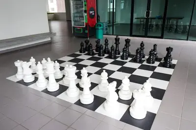 a chess board with white and black chess pieces at One Maxim Sentul By LuxeStay in Kuala Lumpur